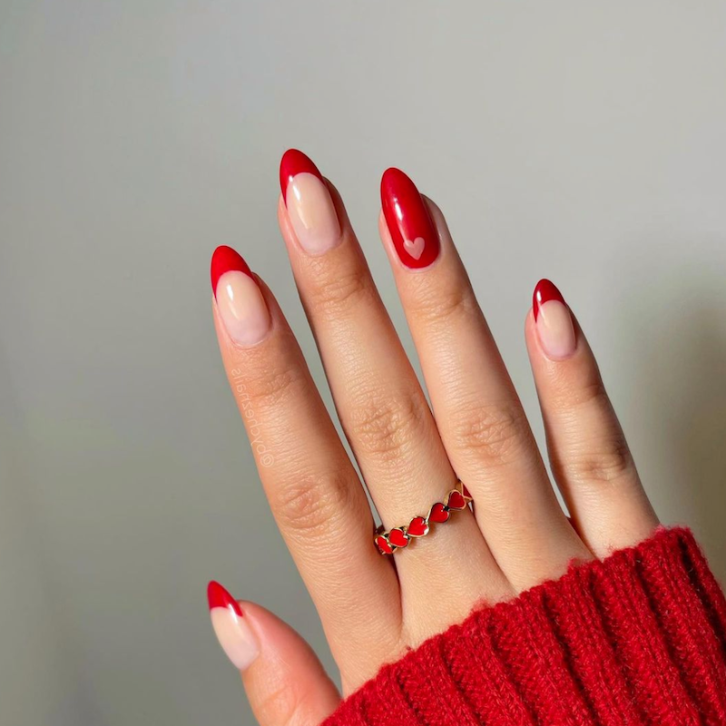 red nail decorations with heart design