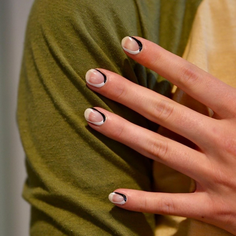 colori unghie autunno meta bianco nero manicure corta bicolore sulla mano di una donna