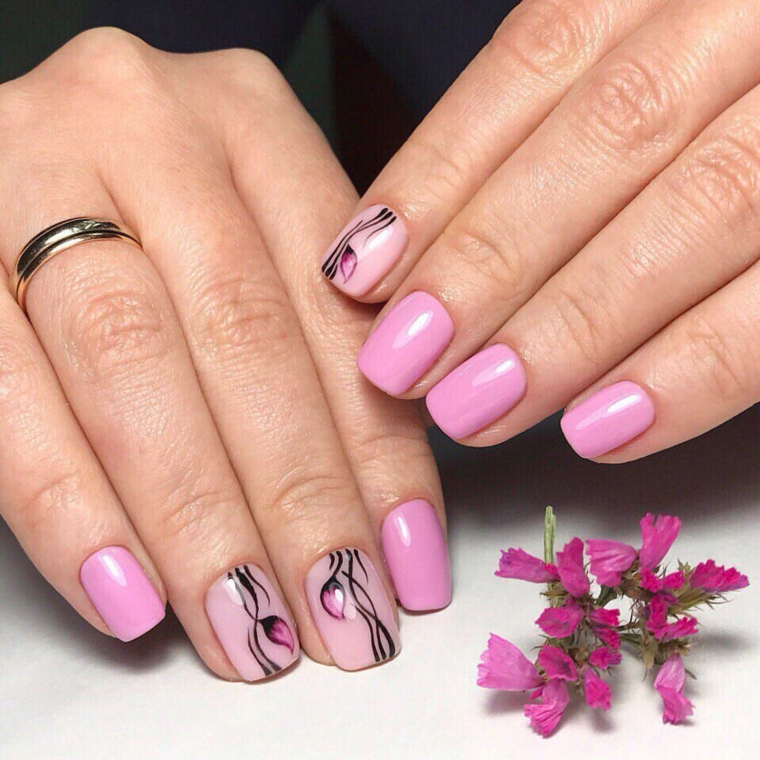 unghie primaverili, una manicure realizzata con dello smalto rosa di diverse tonalità e delle decorazioni